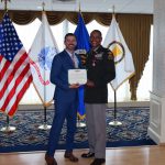 Mark Kitz, Program Executive Officer for Intelligence, Electronic Warfare & Sensors, presents the Legion of Merit to Col. Loyd Beal III for his accomplishments as the Project Manager for Terrestrial Sensors.