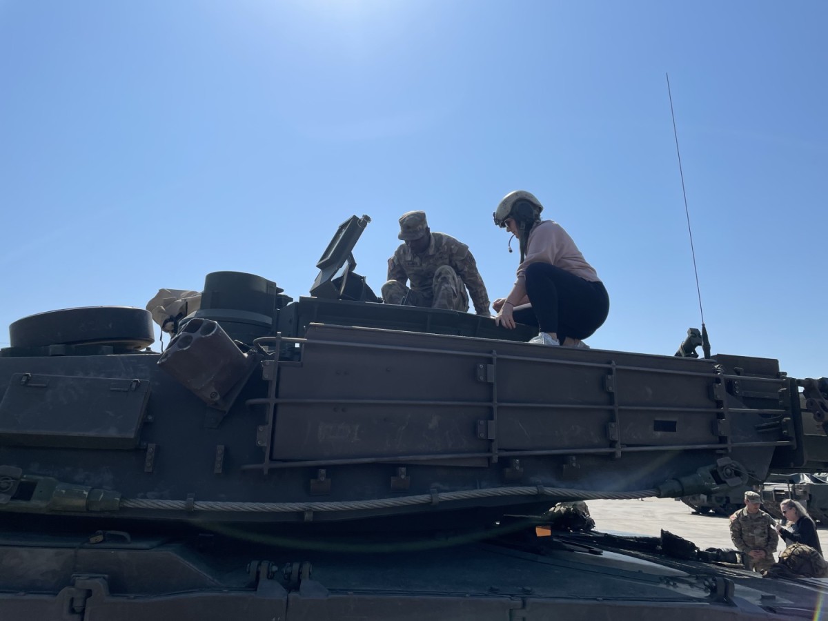 Heather Ferguson, Program Analyst, Project Director Sensors-Aerial Intelligence, takes a tour of a tank from its operator at Fort Stewart, Georgia. (Shawn Nesaw)