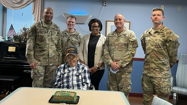 (from left) Chief Warrant Officer 4 Jabar Steward, Capt. Casey Mueller, Kelley Anthony, Assistant Director of Perry Point VA Medical Center, Brig Gen. Ed Barker and Maj. Matthew Szarzynsky celebrated the Army Birthday with veteran Kernie Thompson, seated. (Photo Credit: Allison Weissert)