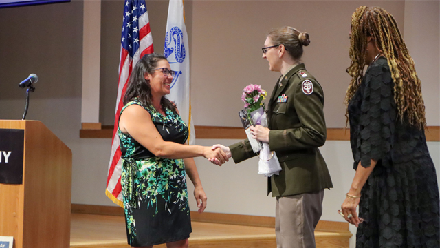 Nicole Karashin, chair of the Aberdeen Proving Ground Federal Women’s Program, shakes hands with Lt. Col. Julia Ryan, deputy commander for nursing at Kirk U.S. Army Health Clinic, after Ryan gave the keynote address at the Women’s Equality Day observance at the Mallette Training Facility Aug. 19, 2024. (Photo Credit: Sierra Merrill, PEO IEW&S)