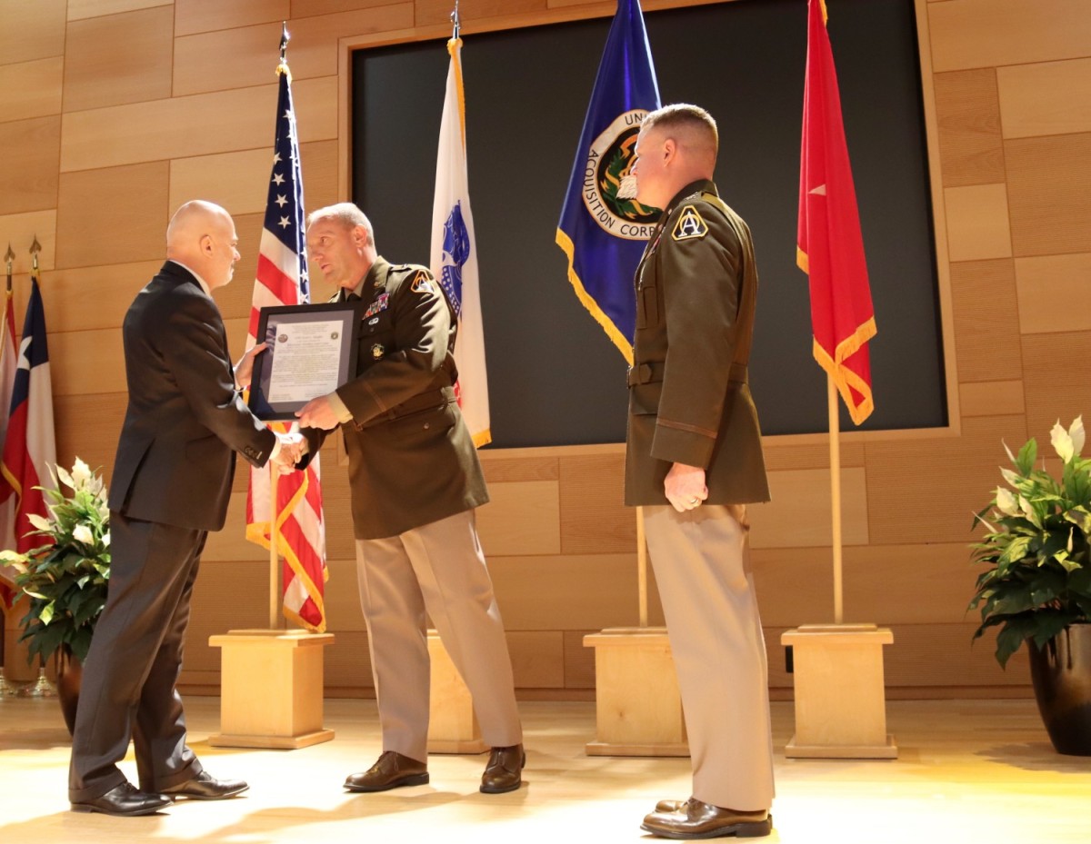 Brig. Gen. Ed Barker (center), the Program Executive Officer for Intelligence, Electronic Warfare & Sensors, passes the charter from Kenneth Strayer (left), outgoing Project Manager for Electronic Warfare & Cyber, to Col. Scott Shaffer (right), the incoming Project Manager. (U.S. Army Photo: Chris Sheeler) Brig. Gen. Ed Barker (center), the Program Executive Officer for Intelligence, Electronic Warfare & Sensors, passes the charter from Kenneth Strayer (left), outgoing Project Manager for Electronic Warfare & Cyber, to Col. Scott Shaffer (right), the incoming Project Manager. (U.S. Army Photo: Chris Sheeler)