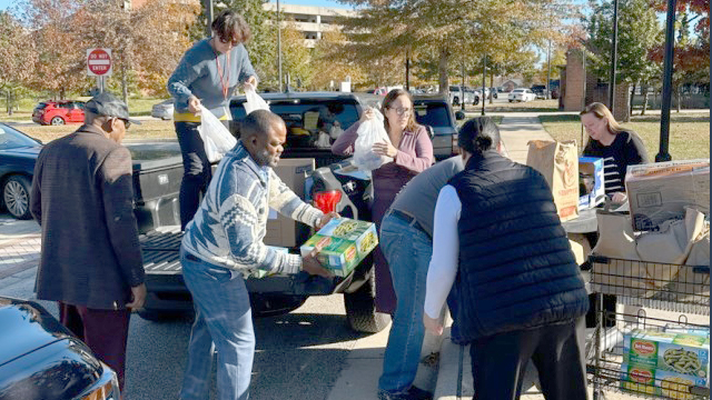 Product Manager Force Protection Systems (PM FPS) and Product Manager Biometrics (PM Biometrics) employees unload food at the Fort Belvoir Food Pantry. (Photo Credit: Sibyll Jones)